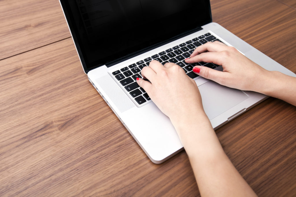 woman typing on a laptop