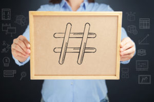 man holding a hashtag cork board